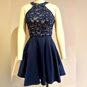 Deep navy halter neck party dress with shimmer lace bodice.
